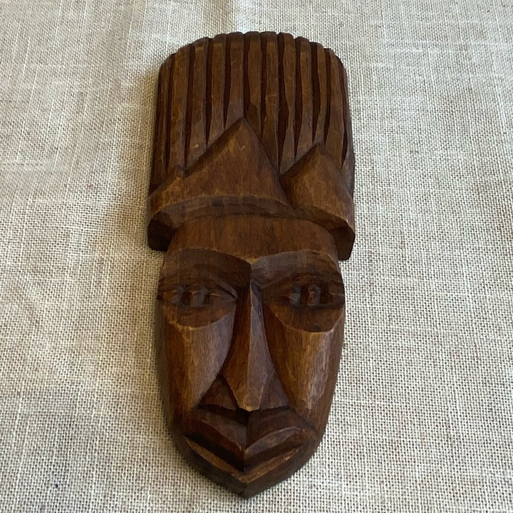 Handmade wood carving of native face sculpture.